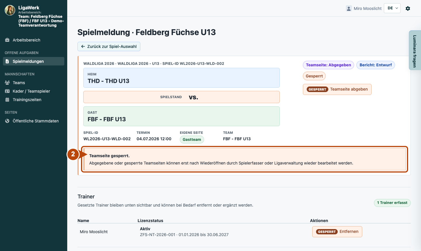 Eigene Teamseite mit Spielkontext, Abgabestatus und Hinweis auf die Bearbeitungssperre; Nummer zwei markiert den Sperrhinweis.